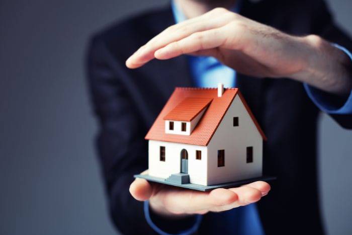 Small model house held in a hand